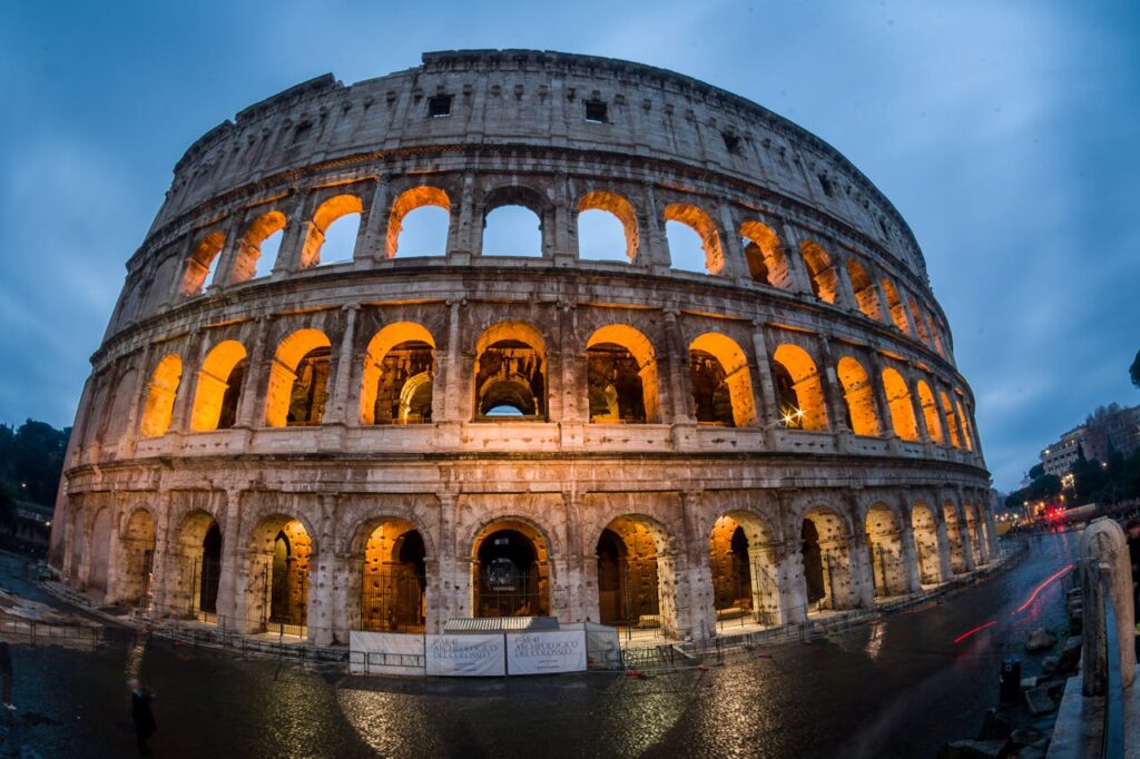 Stunning capture of the illuminated Colosseum in Rome during the evening, showcasing its historic grandeur.
