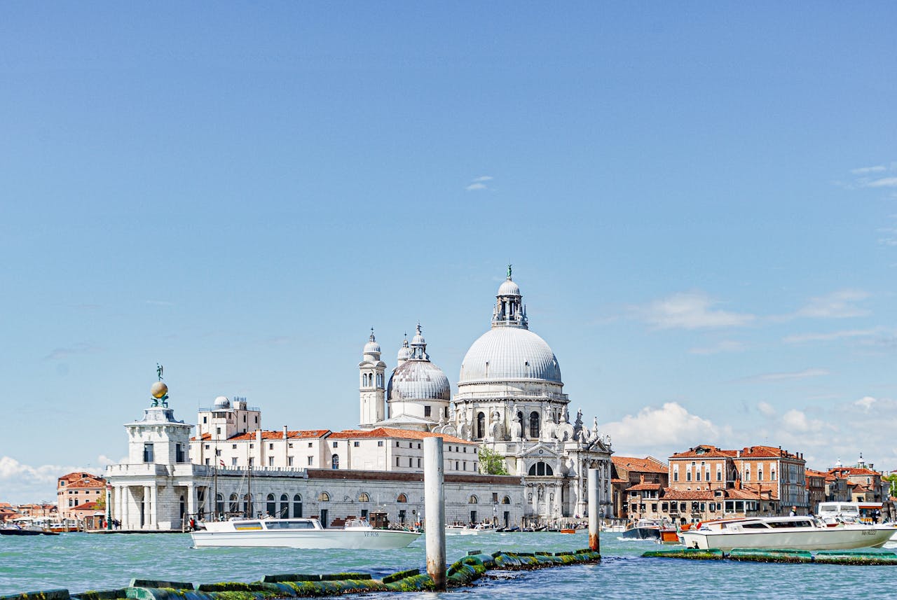 View of Santa Maria della Salute Basilica in Venice, Italy with boats on the Grand Canal.